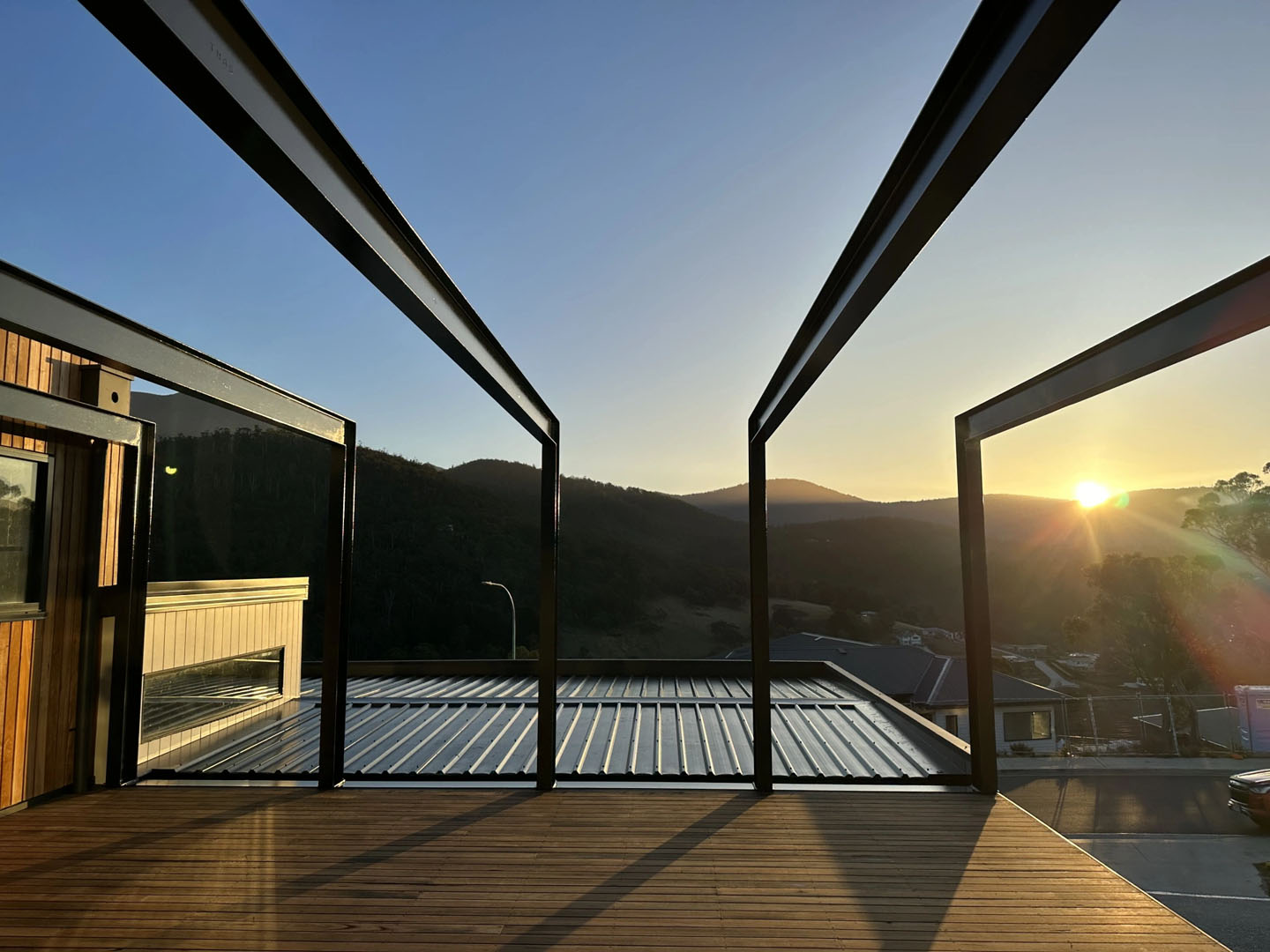 Architectural steelwork framing a residential deck in Lenah Valley at sunset